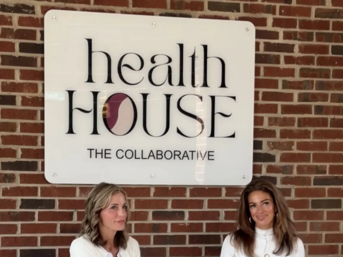 The Collaborative entry with Health House signage on brick
